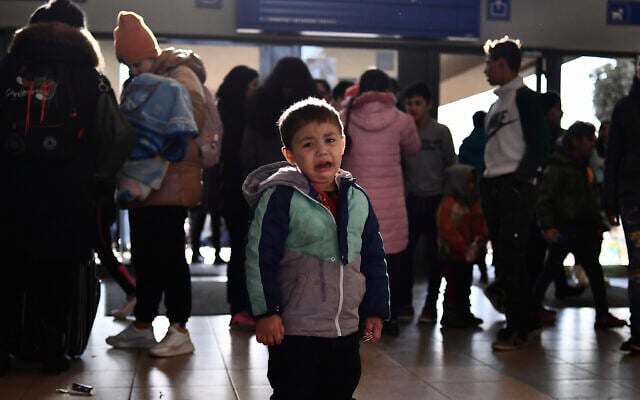 A refugee boy who fled conflict from neighboring Ukraine cries at the railway station after arriving at Zahony, Hungary, February 27, 2022. (AP Photo/Anna Szilagyi) A refugee boy who fled conflict from neighboring Ukraine cries at the railway station after arriving at Zahony, Hungary, February 27, 2022. (AP Photo/Anna Szilagyi)