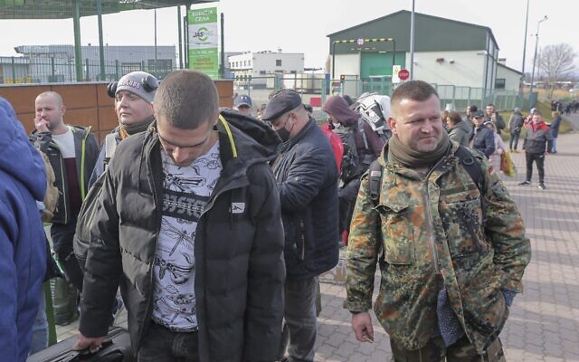 Polish volunteer Jedrzej, 34, in military uniform joins Ukrainians waiting to cross the border to go and fight against Russian forces, at Medyka border crossing, in Poland, on Saturday, February 26, 2022. (AP/Visar Kryeziu) Polish volunteer Jedrzej, 34, in military uniform joins Ukrainians waiting to cross the border to go and fight against Russian forces, at Medyka border crossing, in Poland, on Saturday, February 26, 2022. (AP/Visar Kryeziu)
