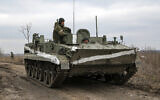 An armored vehicle rolls outside Mykolaivka, Donetsk region, the territory controlled by pro-Russian militants, in eastern Ukraine, Feb. 27, 2022 (AP Photo)