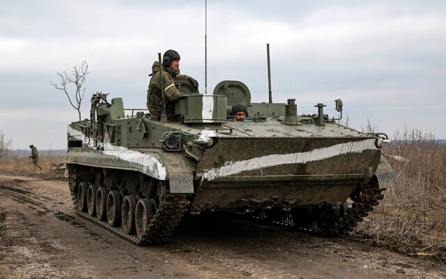 An armored vehicle rolls outside Mykolaivka, Donetsk region, the territory controlled by pro-Russian militants, in eastern Ukraine, Feb. 27, 2022 (AP Photo) An armored vehicle rolls outside Mykolaivka, Donetsk region, the territory controlled by pro-Russian militants, in eastern Ukraine, Feb. 27, 2022 (AP Photo)