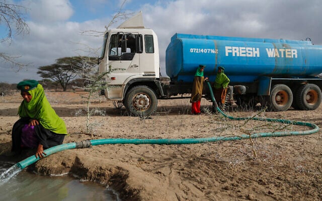 Rangers from the Sabuli Wildlife Conservancy supply water from a tanker for wild animals in the conservancy in Wajir County, Kenya, Oct. 26, 2021.  (Brian Inganga/AP)