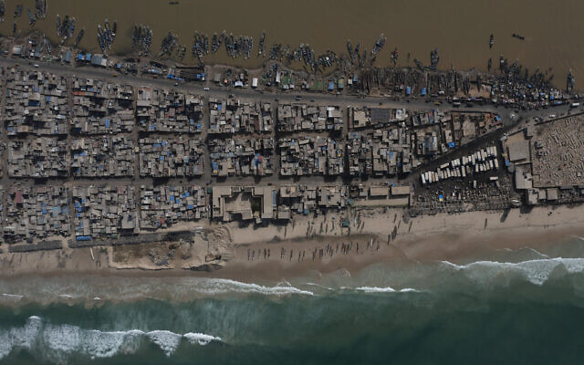 Houses lay between the Senegal river, top, and the Atlantic Ocean beach that has been affected by erosion in Saint Louis, Senegal, Nov. 3, 2021. (Leo Correa/AP)