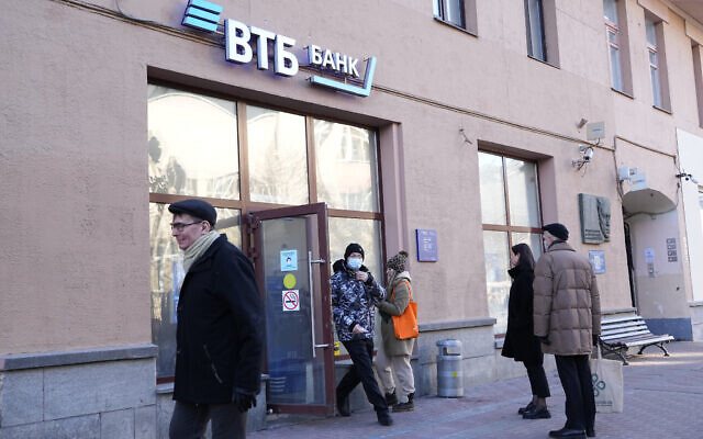 People stand in line to withdraw money from an ATM of VTB Bank in downtown Moscow, Russia, Monday, Feb. 28, 2022. (AP Photo/Pavel Golovkin) People stand in line to withdraw money from an ATM of VTB Bank in downtown Moscow, Russia, Monday, Feb. 28, 2022. (AP Photo/Pavel Golovkin)