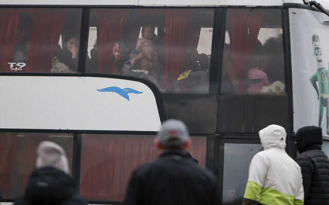 Refugees fleeing conflict in Ukraine arrive by bus at the Medyka border crossing in Poland, Feb. 28, 2022. (Visar Kryeziu/AP)