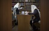 Two Jewish men read prayers in a synagogue in Donetsk, Ukraine, April 18, 2014. (AP Photo/Alexander Zemlianichenko)
