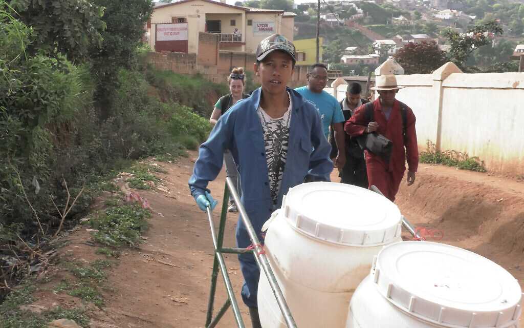The Loowatt waste collection crew making its daily rounds in Antananarivo, Madagascar's capital. The waste is collected in biodegradable bags, which are placed in closed-lid containers and manually loaded into a digester to be converted into fertilizer and biogas. In places where water supply is unreliable, container-based sanitation is a workable alternative. (Credit: Dennis Cieri)