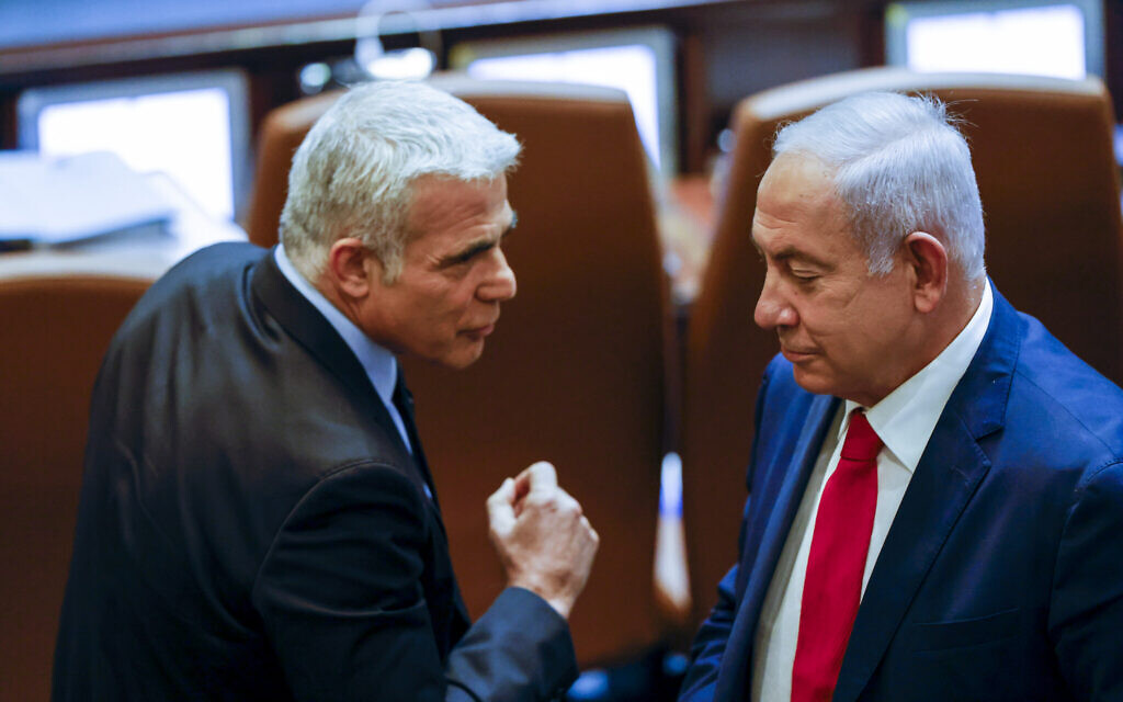 Foreign Minister Yair Lapid (left) with opposition leader Benjamin Netanyahu at a Knesset session in memory of Israel's first prime minister David Ben-Gurion, on November 8, 2021. (Olivier Fitoussi/Flash90) Foreign Minister Yair Lapid (left) with opposition leader Benjamin Netanyahu at a Knesset session in memory of Israel's first prime minister David Ben-Gurion, on November 8, 2021. (Olivier Fitoussi/Flash90)