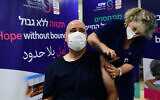Healthcare worker receives a vaccine, at the Sheba Medical Center on January 5, 2022 (Avshalom Sassoni/Flash90)