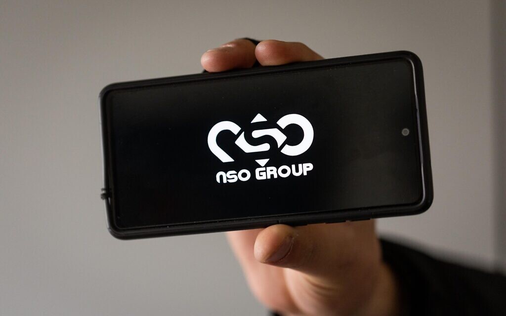 Illustrative: A man holds a phone with the NSO Group logo (Yonatan Sindel/ Flash90) Illustrative: A man holds a phone with the NSO Group logo (Yonatan Sindel/ Flash90)