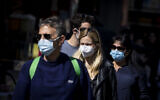 People with face masks shop for groceries at the Mahane Yehuda market in Jerusalem, on February 8, 2022. (Olivier Fitoussi/Flash90)