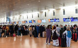 Travelers in the departure hall at Ben Gurion International Airport on February 13, 2022. (Tomer Neuberg/Flash90)