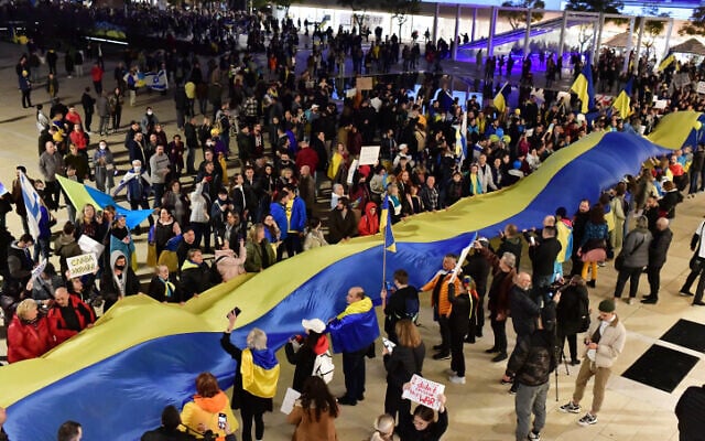 Demonstrators carry placards and flags during a protest march against the Russian invasion of Ukraine, in Tel Aviv, on February 26, 2022 (Tomer Neuberg/Flash90) Demonstrators carry placards and flags during a protest march against the Russian invasion of Ukraine, in Tel Aviv, on February 26, 2022 (Tomer Neuberg/Flash90)
