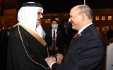 Prime Minister Naftali Bennett (R) is greeted by Bahrain's Foreign Minister Abdullatif bin Rashid Al-Zayani in the capital, Manama, on February 14, 2022. (Haim Zach/GPO)