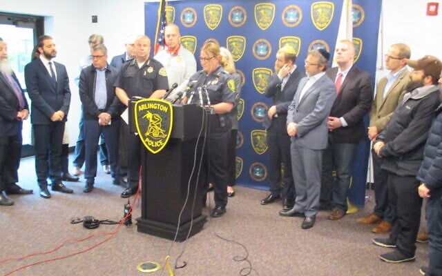 Julie Flaherty, acting police chief of Arlington, MA, addresses a news conference at the town's police station as Rabbi Avi Bukiet (second from left) looks on, on May 17, 2019. (Penny Schwartz via JTA) Julie Flaherty, acting police chief of Arlington, MA, addresses a news conference at the town's police station as Rabbi Avi Bukiet (second from left) looks on, on May 17, 2019. (Penny Schwartz via JTA)