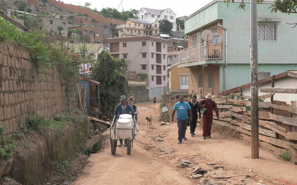 The Loowatt waste collection crew making its daily rounds in Antananarivo, Madagascar's capital. The waste is collected in biodegradable bags, which are placed in closed-lid containers and manually loaded into a digester to be converted into fertilizer and biogas. In places where water supply is unreliable, container-based sanitation is a workable alternative. (Credit: Dennis Cieri)