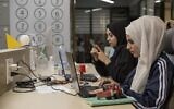 Illustrative: Palestinian entrepreneurs work at a digital tech startup in Ramallah in the West Bank on Oct. 10, 2021. (Ahed Izhiman)