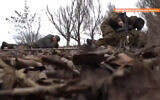 Ukraine's interior minister and soldiers duck for cover outside Novoluganske, in the Donetsk region of eastern Ukraine, on February 19, 2022. (Screenshot/Twitter)