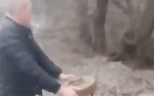 A Ukrainian man removes a mine from a road in Berdyansk, on February 27, 2022. (Screenshot/YouTube) A Ukrainian man removes a mine from a road in Berdyansk, on February 27, 2022. (Screenshot/YouTube)