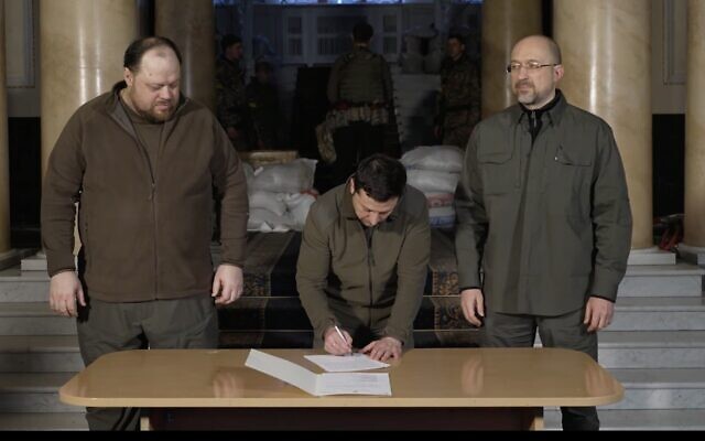 Ukrainian President Volodymyr Zelensky (center) signs an application for Ukraine to join the European Union, on February 28, 2022. (Screenshot/Facebook) Ukrainian President Volodymyr Zelensky (center) signs an application for Ukraine to join the European Union, on February 28, 2022. (Screenshot/Facebook)