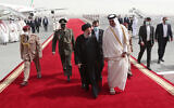 In this photo released by the official website of the office of the Iranian Presidency, President Ebrahim Raisi, center, is welcomed by Qatari Emir Tamim bin Hamad Al Thani, center right, as he arrives in Doha, Qatar, Feb. 21, 2022. (Iranian Presidency Office via AP)
