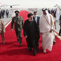 In this photo released by the official website of the office of the Iranian Presidency, President Ebrahim Raisi, center, is welcomed by Qatari Emir Tamim bin Hamad Al Thani, center right, as he arrives in Doha, Qatar, Feb. 21, 2022. (Iranian Presidency Office via AP)