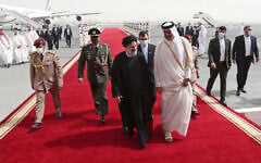 In this photo released by the official website of the office of the Iranian Presidency, President Ebrahim Raisi, center, is welcomed by Qatari Emir Tamim bin Hamad Al Thani, center right, as he arrives in Doha, Qatar, Feb. 21, 2022. (Iranian Presidency Office via AP)