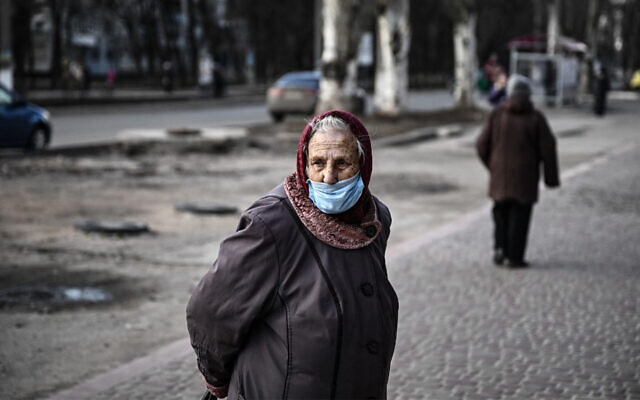A woman stands in a street in the city of Avdiivka, eastern Ukraine, February 21, 2022. (Aris Messinis/AFP/File) A woman stands in a street in the city of Avdiivka, eastern Ukraine, February 21, 2022. (Aris Messinis/AFP/File)