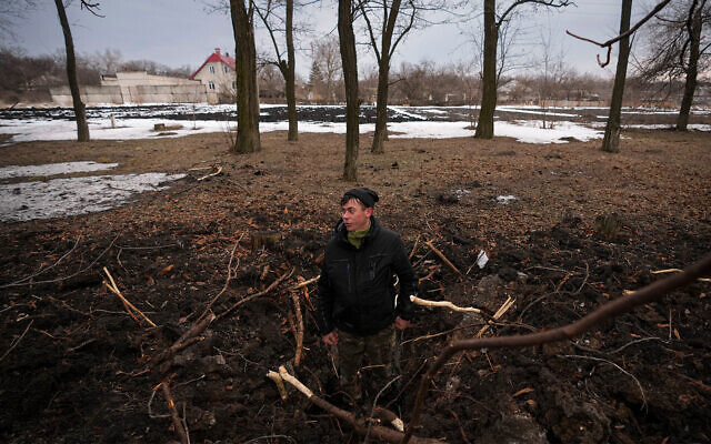 A man stands in a crater from an artillery shell in eastern Ukraine, on February 17, 2022. (AP Photo/Vadim Ghirda) A man stands in a crater from an artillery shell in eastern Ukraine, on February 17, 2022. (AP Photo/Vadim Ghirda)