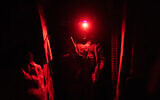A Ukrainian soldier enters a shelter near the line of separation between Ukraine-held territory and rebel-held territory near Zolote, Ukraine, February 19, 2022. (AP/Evgeniy Maloletka)