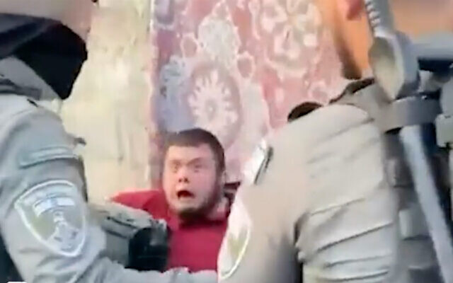 Muhammad Aljoni, a young man with Down syndrome, grapples with police at a protest in Sheikh Jarrah, East Jerusalem, on February 21, 2022. (Screenshot) Muhammad Aljoni, a young man with Down syndrome, grapples with police at a protest in Sheikh Jarrah, East Jerusalem, on February 21, 2022. (Screenshot)