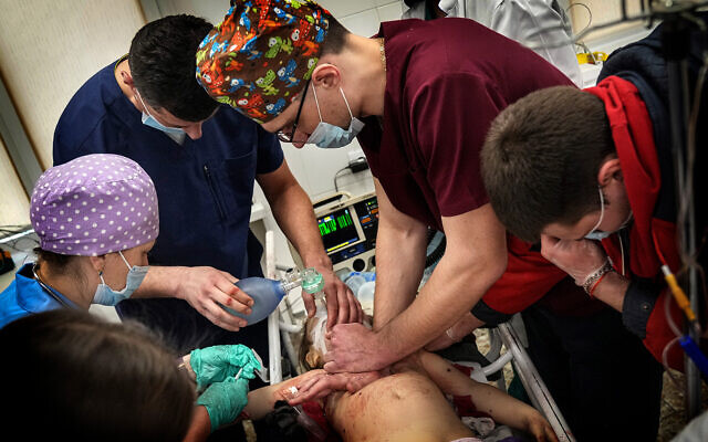Medics perform CPR on a girl at the city hospital of Mariupol, who was injured during shelling in a residential area in eastern Ukraine, on February 27, 2022. The girl did not survive. (AP Photo/Evgeniy Maloletka) Medics perform CPR on a girl at the city hospital of Mariupol, who was injured during shelling in a residential area in eastern Ukraine, on February 27, 2022. The girl did not survive. (AP Photo/Evgeniy Maloletka)