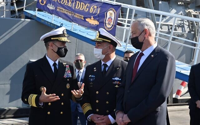 Defense Minister Benny Gantz, right, along with Israeli Navy chief David Salama, center, speak with the head of the US Navy's 5th Fleet, Admiral Brad Cooper, in front of the USS Cole in Bahrain on February 3, 2022. (Ariel Hermoni/Defense Ministry) Defense Minister Benny Gantz, right, along with Israeli Navy chief David Salama, center, speak with the head of the US Navy's 5th Fleet, Admiral Brad Cooper, in front of the USS Cole in Bahrain on February 3, 2022. (Ariel Hermoni/Defense Ministry)