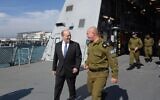 Prime Minsiter Naftali Bennett walks with the head of the Israeli Navy David Salama during a visit to the navy's Haifa Base, on February 8, 2022. (Amos Ben-Gershon/Government Press Office)