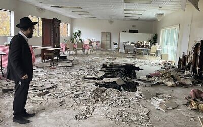 Rabbi Mendel Weinfeld surveys the damage at the Chabad House in south San Jose, December 2021. (Emma Goss via JTA)