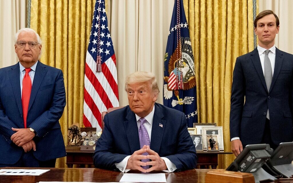 US president Donald Trump, center, is flanked by then-ambassador to Israel David Friedman, left, and then-senior adviser Jared Kushner in the Oval Office of the White House in Washington on August 12, 2020. (AP/Andrew Harnik) US president Donald Trump, center, is flanked by then-ambassador to Israel David Friedman, left, and then-senior adviser Jared Kushner in the Oval Office of the White House in Washington on August 12, 2020. (AP/Andrew Harnik)