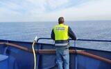 An Environment Ministry worker aboard the Bat Galim ship on February 2, 2022. (Ram Greenwald/Environment Ministry)