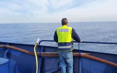 An Environment Ministry worker aboard the Bat Galim ship on February 2, 2022. (Ram Greenwald/Environment Ministry)