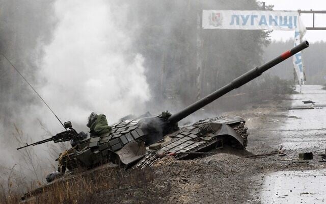 Smoke rises from a Russian tank destroyed by the Ukrainian forces on the side of a road in Lugansk region, on February 26, 2022. (Anatolii Stepanov/AFP) Smoke rises from a Russian tank destroyed by the Ukrainian forces on the side of a road in Lugansk region, on February 26, 2022. (Anatolii Stepanov/AFP)