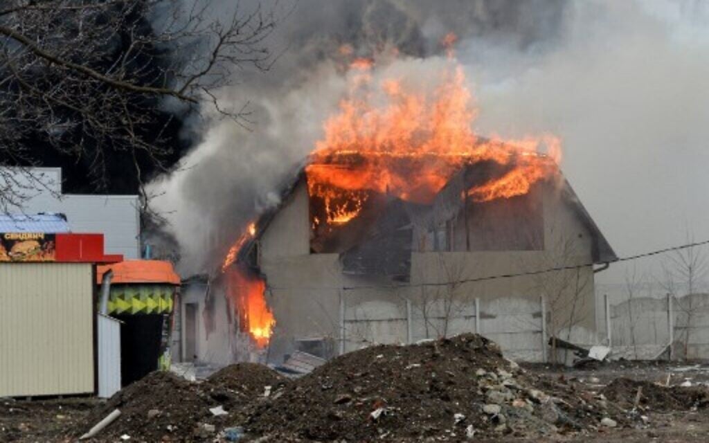 A burning building is pictured after the shelling is said by Russian forces in Ukraine's second-biggest city of Kharkiv, on March 3, 2022. (Sergey Bobok/AFP)