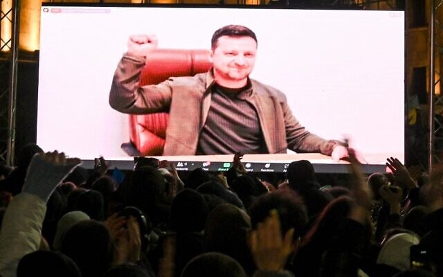 Demonstrators watch an address of Ukrainian President Volodymyr Zelensky on the big screen during a rally in support of Ukraine in Tbilisi, on March 4, 2022. (Vano Shlamov/AFP) Demonstrators watch an address of Ukrainian President Volodymyr Zelensky on the big screen during a rally in support of Ukraine in Tbilisi, on March 4, 2022. (Vano Shlamov/AFP)