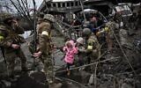 People cross a destroyed bridge as they evacuate the city of Irpin, northwest of Kyiv, during heavy shelling and bombing on March 5, 2022, 10 days after Russia launched a military invasion on Ukraine. (Aris Messinis/AFP)