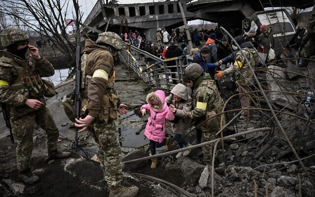 People cross a destroyed bridge as they evacuate the city of Irpin, northwest of Kyiv, during heavy shelling and bombing on March 5, 2022, 10 days after Russia launched a military invasion on Ukraine. (Aris Messinis/AFP) People cross a destroyed bridge as they evacuate the city of Irpin, northwest of Kyiv, during heavy shelling and bombing on March 5, 2022, 10 days after Russia launched a military invasion on Ukraine. (Aris Messinis/AFP)