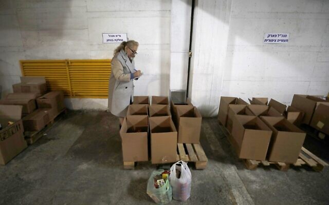 Volunteers in the Israeli northern town of Nof Hagalil gather objects donated to welcome  refugees fleeing the war in Ukraine, on March 6, 2022. (JALAA MAREY / AFP)