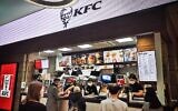 Customers stand in front of a US Kentucky Fried Chicken (KFC) fast food kiosk in Evroreisky (European) shopping mall in Moscow on March 7, 2022. (Photo by AFP)