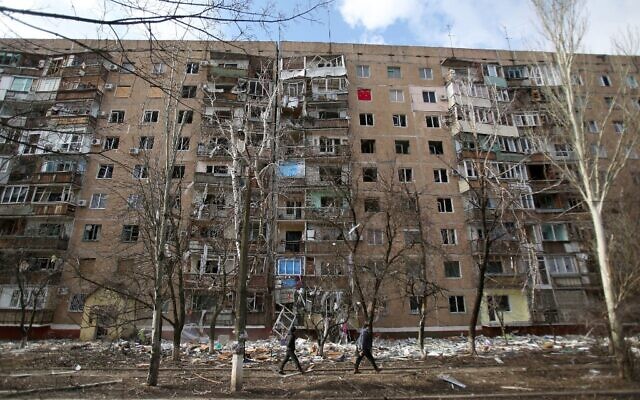 People walk in front of a multi-story building that was badly damaged as a result of Russian missile explosion after it was shot down over the city by Ukrainian air defense on March 6, in Kramatorsk on March 7, 2022. (Anatolii Stepanov / AFP) People walk in front of a multi-story building that was badly damaged as a result of Russian missile explosion after it was shot down over the city by Ukrainian air defense on March 6, in Kramatorsk on March 7, 2022. (Anatolii Stepanov / AFP)