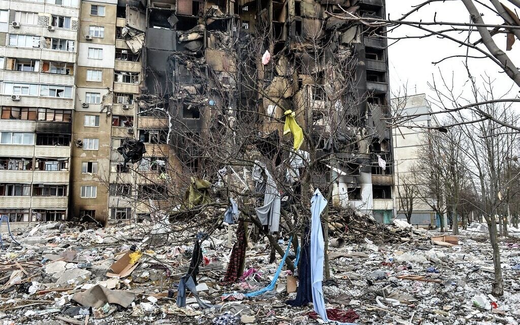 This picture shows an apartment building damaged after shelling the day before in Ukraine's second-biggest city of Kharkiv on March 8, 2022. (Sergey BOBOK / AFP)