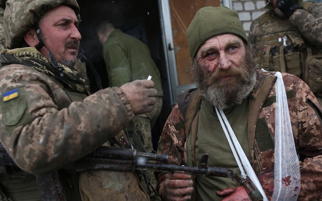 A wounded servicemen of Ukrainian Military Forces looks on after the battle with Russian troops and Russia-backed separatists in Luhansk region on March 8, 2022 (Anatolii Stepanov / AFP)