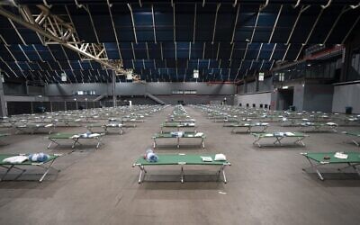 This photograph taken on  March 9, 2022 shows beds in a shelter hub to welcome the first Ukrainian family in the Jaarbeurs Utrecht, The Netherlands. (Jeroen JUMELET / ANP / AFP)