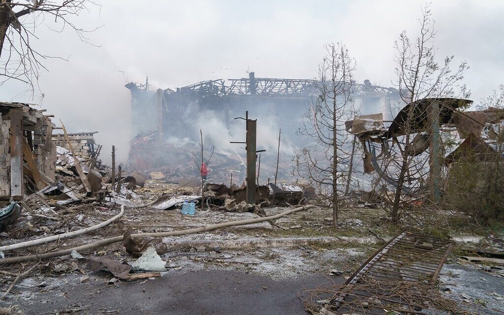 Firefighters spray water on a destroyed shoe factory following an airstrike in Dnipro, Ukraine on March 11, 2022. (Emre Caylak / AFP)