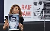 In this file photo taken on December 16, 2015, Ensaf Haidar holds a picture of her husband Raif Badawi after accepting the European Parliament's Sakharov human rights prize on behalf of her husband, at the European Parliament in Strasbourg, in eastern France. (Patrick Hertzog/AFP)